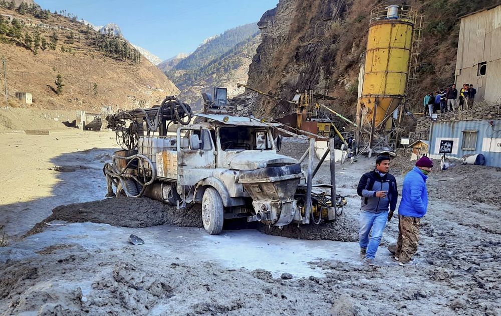 Chamoli: Locals inspect the site near damaged Dhauliganga hydropower project at Reni village, after a glacier broke off in Joshimath causing a massive flood in the Dhauli Ganga river, in Chamoli district of Uttarakhand, Sunday, Feb. 7, 2021. (PTI Photo)